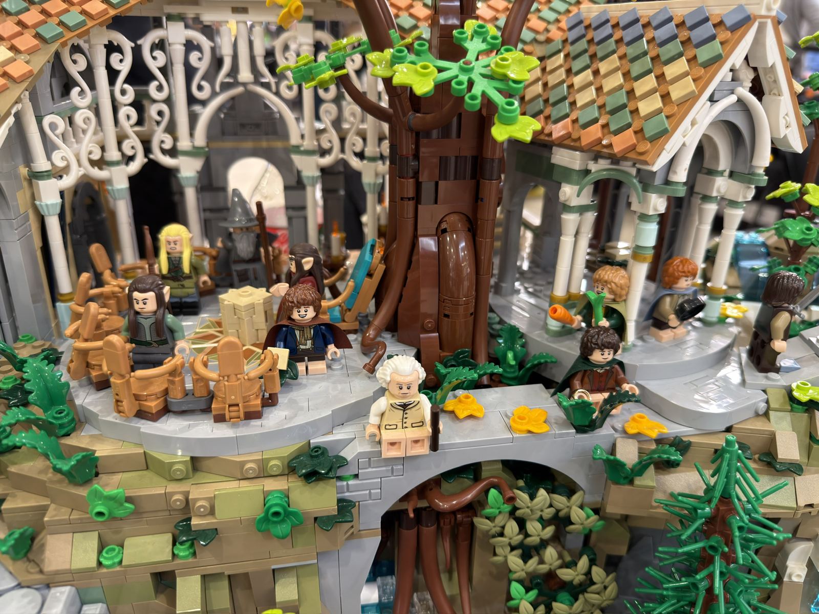 Close-up of a LEGO Rivendell build with elves and hobbit minifigures on a stone bridge