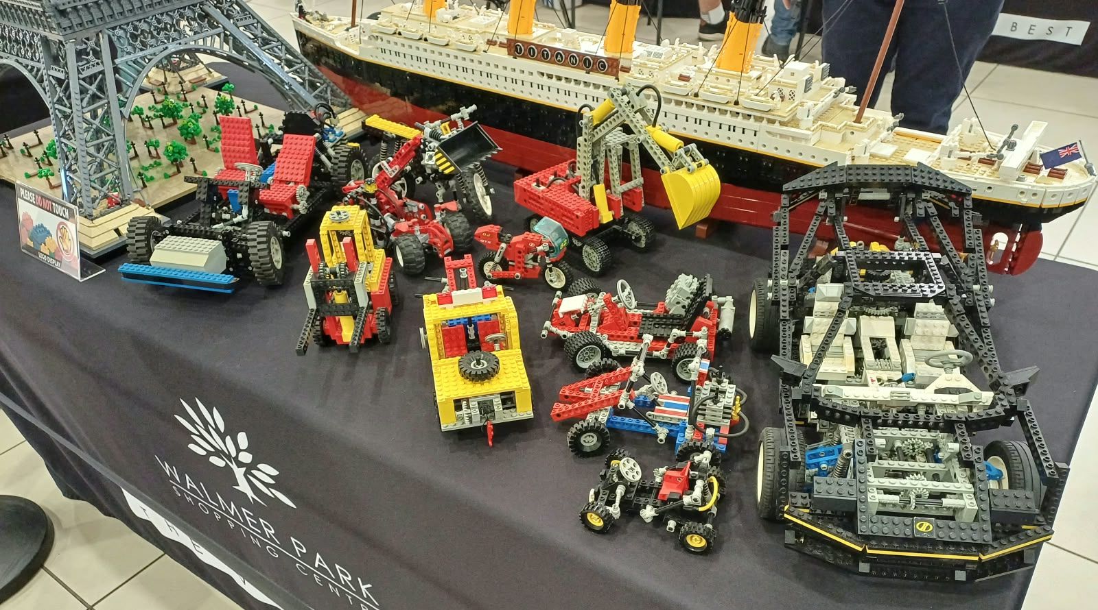 Vintage LEGO Technic vehicles in front of a large LEGO Titanic